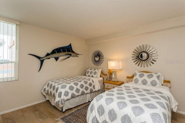 17900 Gulf Blvd Unit 1B, Redington Shores, FL 33708 - bedroom featuring wood finished floors, baseboards, and a textured ceiling
