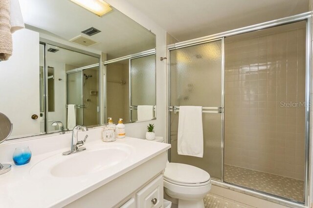 17900 Gulf Blvd Unit 1B, Redington Shores, FL 33708 - bathroom with a stall shower, vanity, and toilet