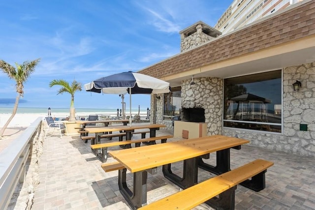 17900 Gulf Blvd Unit 1B, Redington Shores, FL 33708 - view of patio featuring view of water and beach and outdoor dining area