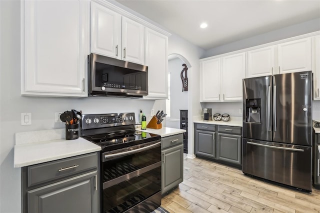 3046 Donington Castle Ln, Land O Lakes, FL 34638 - kitchen with appliances with stainless steel finishes, gray cabinetry, white cabinetry, light wood-style floors, and recessed lighting