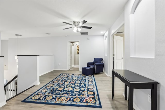 3046 Donington Castle Ln, Land O Lakes, FL 34638 - sitting room featuring an upstairs landing, wood finished floors, a ceiling fan, and baseboards