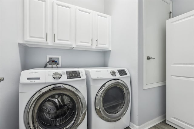 3046 Donington Castle Ln, Land O Lakes, FL 34638 - laundry room featuring cabinet space, washer and dryer, wood finished floors, and baseboards