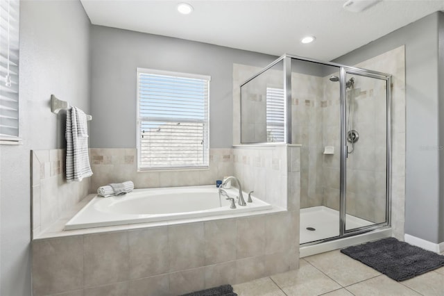3046 Donington Castle Ln, Land O Lakes, FL 34638 - bathroom featuring tile patterned flooring, a stall shower, a bath, and recessed lighting