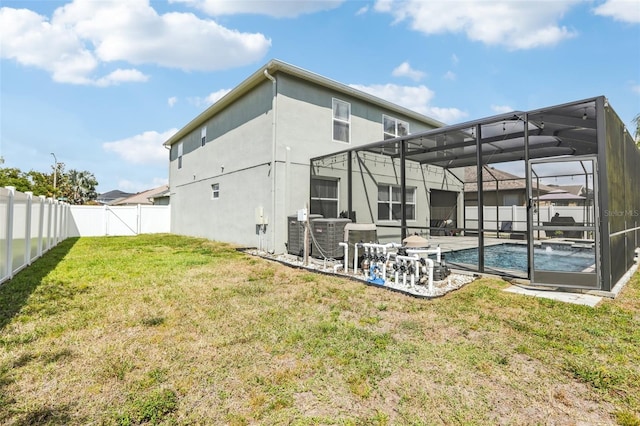3046 Donington Castle Ln, Land O Lakes, FL 34638 - rear view of property with stucco siding, a patio area, and central AC