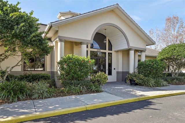 3046 Donington Castle Ln, Land O Lakes, FL 34638 - property entrance with stucco siding and a tiled roof