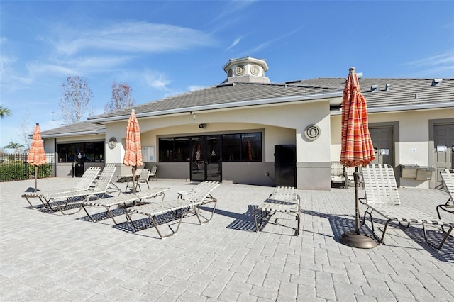 3046 Donington Castle Ln, Land O Lakes, FL 34638 - back of property featuring a patio area, stucco siding, and fence