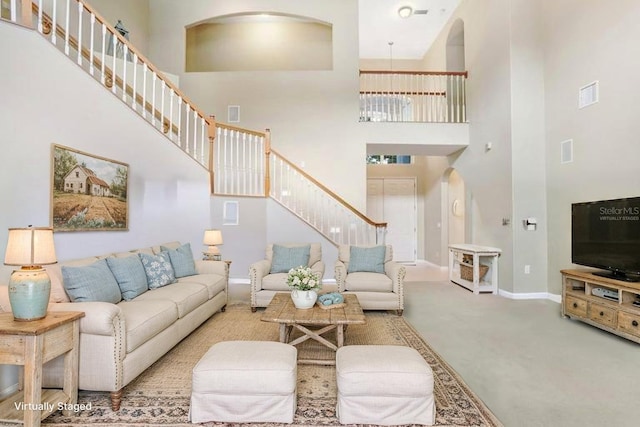 808 Hickory Glen Dr, Seffner, FL 33584 - living area with a high ceiling, arched walkways, stairs, and carpet