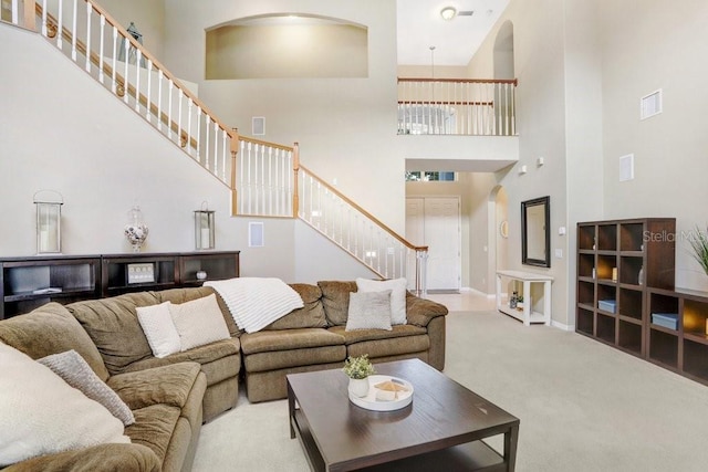 808 Hickory Glen Dr, Seffner, FL 33584 - carpeted living area with a towering ceiling, stairway, and arched walkways