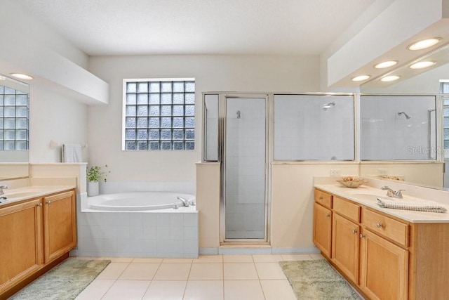 808 Hickory Glen Dr, Seffner, FL 33584 - bathroom with two vanities, a stall shower, a garden tub, and tile patterned floors