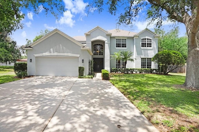 808 Hickory Glen Dr, Seffner, FL 33584 - view of front facade featuring an attached garage, a front yard, concrete driveway, and stucco siding