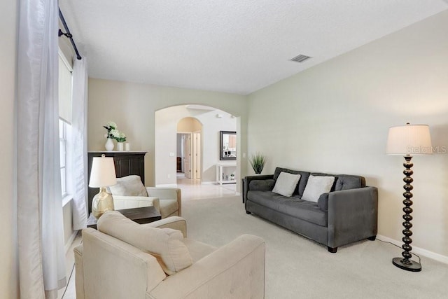 808 Hickory Glen Dr, Seffner, FL 33584 - carpeted living area with arched walkways and healthy amount of natural light