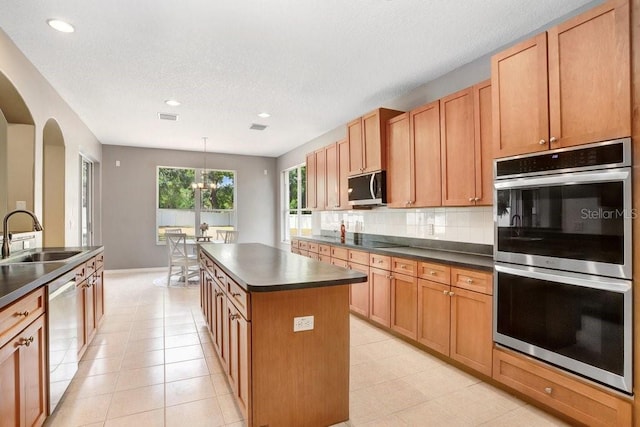 808 Hickory Glen Dr, Seffner, FL 33584 - kitchen with stainless steel appliances, dark countertops, a center island, tasteful backsplash, and recessed lighting
