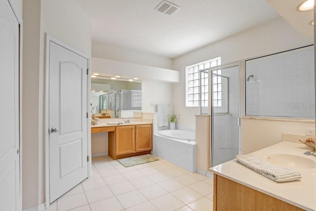 808 Hickory Glen Dr, Seffner, FL 33584 - full bath with two vanities, a shower stall, a garden tub, and tile patterned flooring