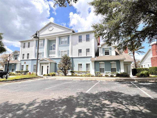 7673 Heritage Crossing Way Unit 202, Reunion, FL 34747 - view of property featuring uncovered parking