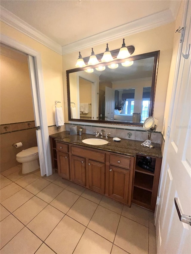 7673 Heritage Crossing Way Unit 202, Reunion, FL 34747 - bathroom featuring tile patterned flooring, crown molding, toilet, and vanity