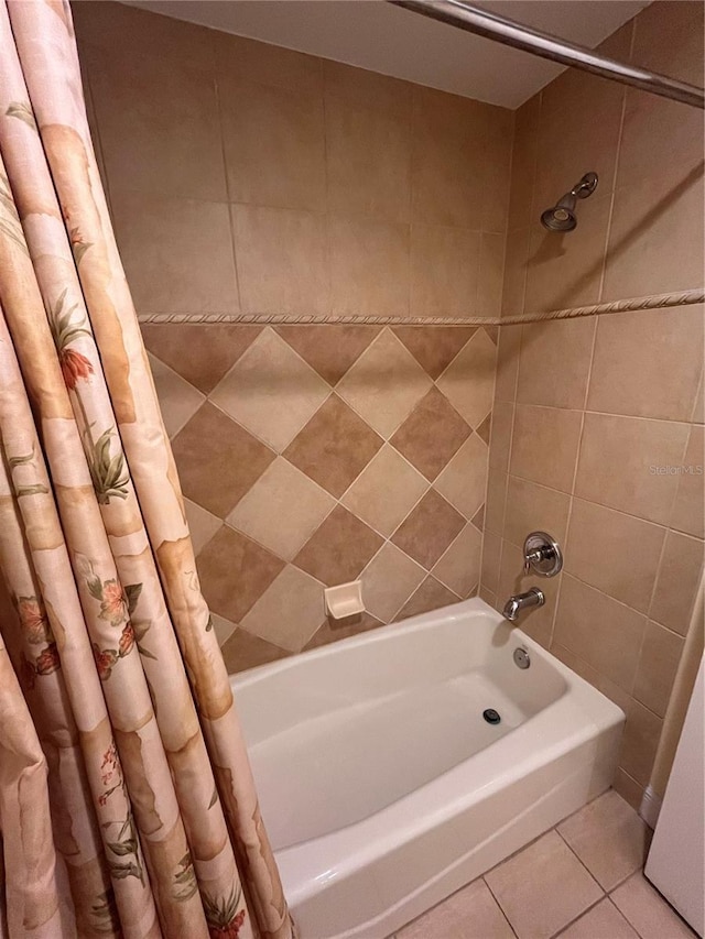 7673 Heritage Crossing Way Unit 202, Reunion, FL 34747 - bathroom with shower / bath combination with curtain and tile patterned flooring
