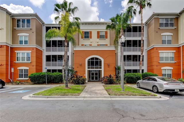 view of property featuring uncovered parking