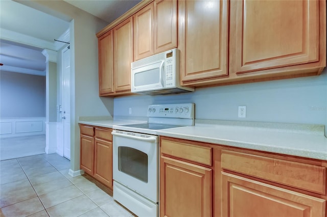 kitchen featuring ornamental molding, light brown cabinets, white appliances, light countertops, and light tile patterned floors