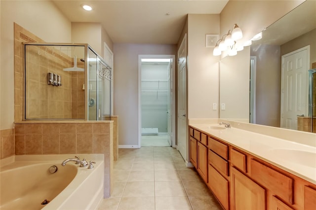 full bath with tile patterned flooring, a sink, a bath, and a stall shower