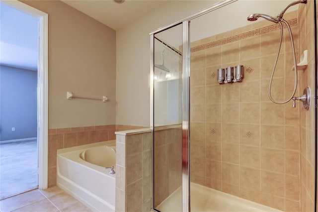 full bath with tile patterned floors, a shower stall, and a garden tub