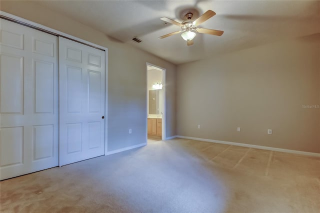 unfurnished bedroom with baseboards, light colored carpet, visible vents, and a closet