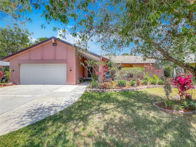 single story home featuring a front lawn, a garage, board and batten siding, stucco siding, and concrete driveway