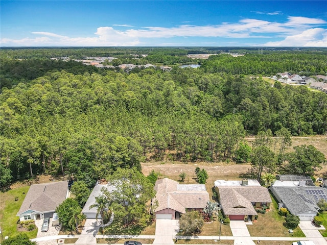 birds eye view of property featuring a view of trees and a residential view