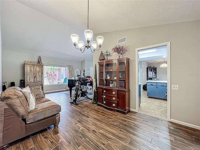 interior space featuring baseboards, dark wood-style floors, a chandelier, and visible vents