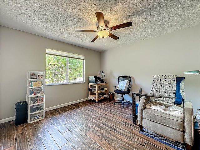 home office with baseboards, a ceiling fan, a textured ceiling, and wood finished floors