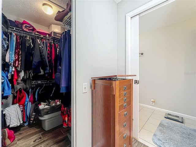 spacious closet featuring tile patterned floors