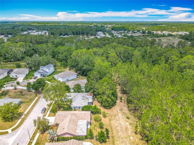 aerial view featuring a forest view and a residential view