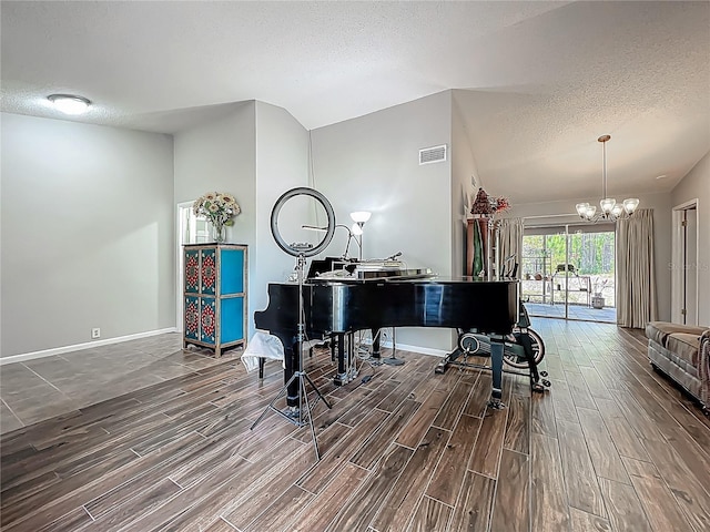 3932 Watson Dr, New Port Richey, FL 34655 - sitting room with a notable chandelier, a textured ceiling, and wood finished floors
