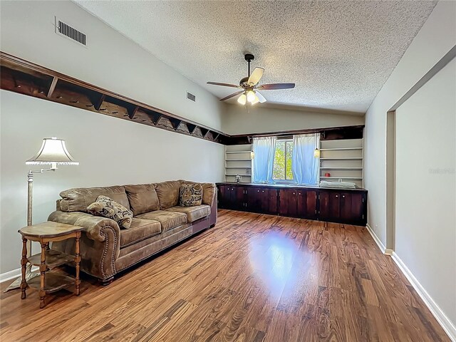 3932 Watson Dr, New Port Richey, FL 34655 - living room with wood finished floors, a textured ceiling, visible vents, vaulted ceiling, and a ceiling fan