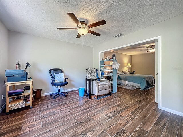 3932 Watson Dr, New Port Richey, FL 34655 - bedroom featuring a textured ceiling, visible vents, baseboards, ceiling fan, and wood finish floors