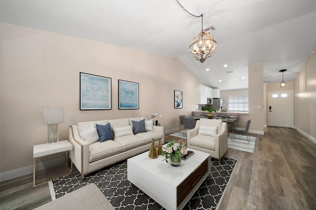 2170 Elm St Unit 906, Dunedin, FL 34698 - living area with baseboards, an inviting chandelier, wood finished floors, and lofted ceiling