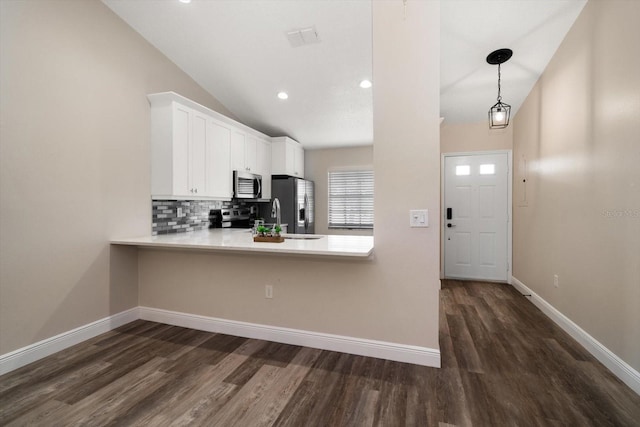 2170 Elm St Unit 906, Dunedin, FL 34698 - kitchen featuring a sink, dark wood finished floors, appliances with stainless steel finishes, backsplash, and vaulted ceiling