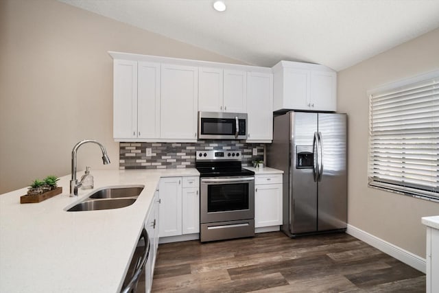 2170 Elm St Unit 906, Dunedin, FL 34698 - kitchen featuring appliances with stainless steel finishes, tasteful backsplash, a sink, light countertops, and lofted ceiling