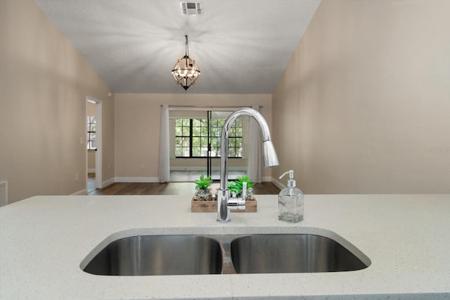 2170 Elm St Unit 906, Dunedin, FL 34698 - details with decorative light fixtures, visible vents, wood finished floors, a sink, and light stone counters