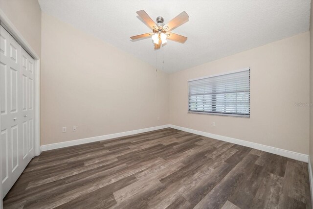 2170 Elm St Unit 906, Dunedin, FL 34698 - unfurnished bedroom featuring baseboards, dark wood-type flooring, and a closet