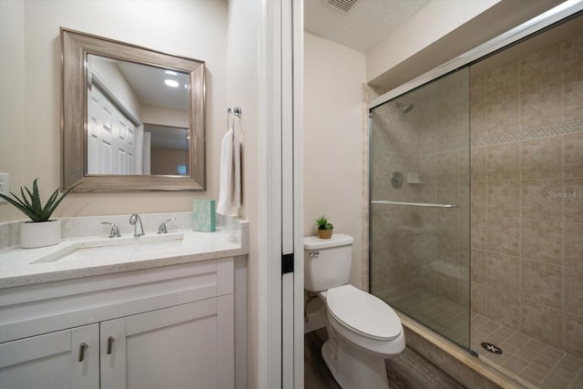 2170 Elm St Unit 906, Dunedin, FL 34698 - bathroom featuring vanity, a shower stall, toilet, and visible vents