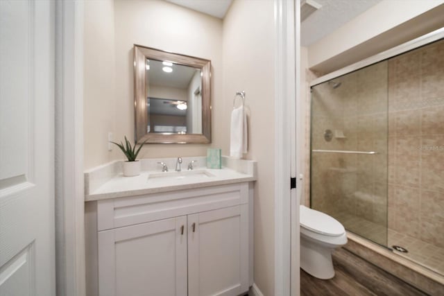 2170 Elm St Unit 906, Dunedin, FL 34698 - full bathroom featuring vanity, a stall shower, toilet, and wood finished floors