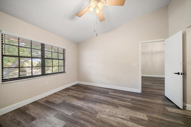 2170 Elm St Unit 906, Dunedin, FL 34698 - spare room with baseboards, ceiling fan, dark wood finished floors, and lofted ceiling