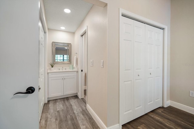 2170 Elm St Unit 906, Dunedin, FL 34698 - corridor with baseboards, a sink, wood finished floors, and recessed lighting