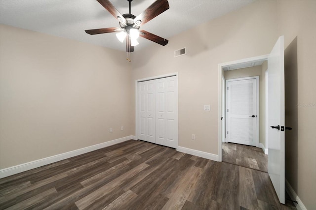 2170 Elm St Unit 906, Dunedin, FL 34698 - unfurnished bedroom with ceiling fan, dark wood finished floors, baseboards, visible vents, and a closet