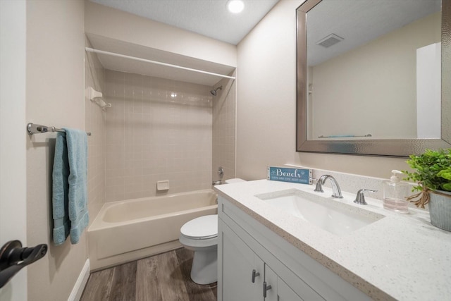 2170 Elm St Unit 906, Dunedin, FL 34698 - full bath with visible vents, vanity, wood finished floors, toilet, and washtub / shower combination