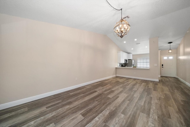 2170 Elm St Unit 906, Dunedin, FL 34698 - unfurnished living room featuring a notable chandelier, dark wood finished floors, recessed lighting, baseboards, and vaulted ceiling