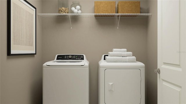 washroom featuring laundry area and washer and clothes dryer
