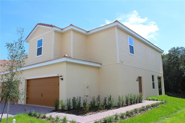 587 Bay Leaf Dr, Poinciana, FL 34759 - view of side of home with a garage and stucco siding