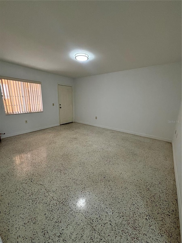 2921 SW 10th St Unit 23, Miami, FL 33135 - unfurnished room featuring speckle patterned floor and baseboards