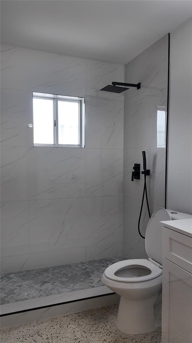 2921 SW 10th St Unit 23, Miami, FL 33135 - bathroom with a marble finish shower, speckled floor, and vanity
